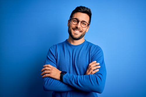 handsome man with beard wearing casual sweater and glasses